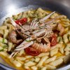 Gnocchi con scampi e pomodorini in salsa.