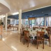 Ristorante elegante con tavoli apparecchiati e sedie in legno.